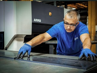 Askon employee processes workpiece